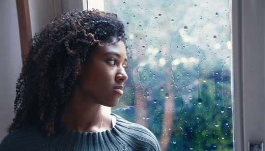depressed-woman-looking-out-window